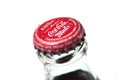 Drops of water on Cocacola capsule on white background on top view