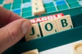 Plastic letters on Scrabble board game forming the word : Job