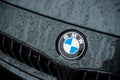 rain drops on BMW logo on black car front parked in the street Royalty Free Stock Photo