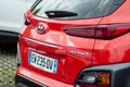 Red Hyundai Kona crossover rear view in retailer showroom