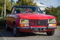 Front view of orange Peugeot 304 vintage car parked in the street Royalty Free Stock Photo