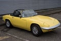 Front view of Yellow vintage Lotus Elan roadster parked in the street