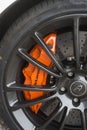 Orange brake on mc laren sport car parked in the street Royalty Free Stock Photo