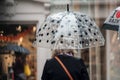 Portrait of woman walking with transparent umbrella in the pedestrian street Royalty Free Stock Photo