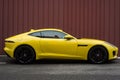 Profile view of yellow Jaguar F-Type parked in the street