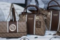 Brown leather hand bags collection by Guess in a luxury fashion store showroom Royalty Free Stock Photo