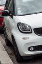 Closeup of front view of white smart car parked in the street