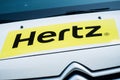 Closeup of Hertz logo on rental vehicle parked in the street Royalty Free Stock Photo