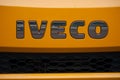 Iveco logo on orange truck front parked in the street