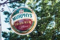 Closeup of Murphy`s pub logo on signboard in the street Royalty Free Stock Photo