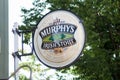 Closeup of Murphy`s pub logo on signboard in the street Royalty Free Stock Photo