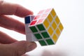 Closeup of Rubik`s cube in hand on white background Royalty Free Stock Photo