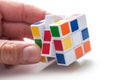 Closeup of Rubik`s cube in hand on white background Royalty Free Stock Photo