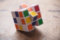 Rubik`s cube on wooden table background Royalty Free Stock Photo