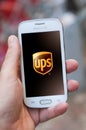 Closeup of UPS logo on smartphone screen in hand from Samsung brand in the street