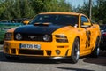 Front view of orange and black ford mustang 500 GT cars parked in the street Royalty Free Stock Photo