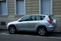 Profile view of grey Toyota rav4 crossover parked in the street