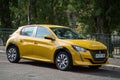 Profile view of Yellow Peugeot 208 electric parked in the street Royalty Free Stock Photo
