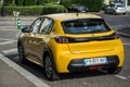 Rear view of Yellow Peugeot 208 electric parked in the street