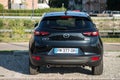 Rear view of black Mazda CX3 crossover parked in the street