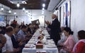Mullah prays during celebration Muslim holiday end of Ramadan, men and women sit at tables in the Crimean Tartar restaurant