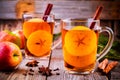 Mulled apple cider with cinnamon and anis in glass mugs
