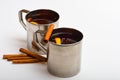 Mulled wine or beverage with cinnamon and anise. Tea or hot drink in metal mug with slise of orange. Hot beverage