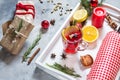 Mulled wine, a bottle of red wine, spruce branches, cinnamon, orange and lemon on white tray on concrete background. Winter drinks Royalty Free Stock Photo