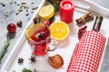 Mulled wine, a bottle of red wine, spruce branches, cinnamon, orange and lemon on white tray on concrete background. Winter drinks Royalty Free Stock Photo