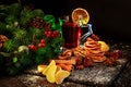 mulled wine on Christmas table decorated with nuts, tangerines, cinnamon, Christmas tree branches , Royalty Free Stock Photo