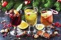 Mulled wine and mulled cider. Hot winter drinks and cocktails for christmas or new year`s eve in glass mugs with spices and citru