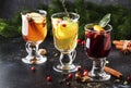 Mulled wine and mulled cider. Hot winter drinks and cocktails for christmas or new year`s eve in glass mugs with spices and citru Royalty Free Stock Photo