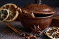 Mulled wine flavoring: cinnamon, star anise, orange skins in a brown bowl