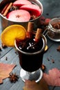 Mulled wine. Glass of winter hot drink with citrus, apple and spices. Royalty Free Stock Photo