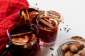 Mulled wine in glasses with orange and spices near red sweater