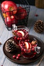 Mulled wine in glasses on a wooden background. Apples, cranberries, cinnamon, star anise. Royalty Free Stock Photo