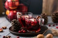 Mulled wine in glasses on a wooden background. Apples, cranberries, cinnamon, star anise. Royalty Free Stock Photo