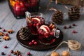 Mulled wine in glasses on a wooden background. Apples, cranberries, cinnamon, star anise. Royalty Free Stock Photo