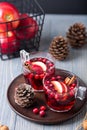 Mulled wine in glasses on a wooden background. Apples, cranberries, cinnamon, star anise. Royalty Free Stock Photo