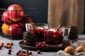 Mulled wine in glasses on a wooden background. Apples, cranberries, cinnamon, star anise. Royalty Free Stock Photo