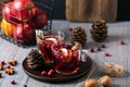 Mulled wine in glasses on a wooden background. Apples, cranberries, cinnamon, star anise Royalty Free Stock Photo