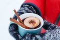 Mulled wine in hand in winer outdoor