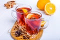 Mulled wine, Hot winter drink with berries, orange,spices, cinnamon in glass cups on the white wooden table with ingredients and s Royalty Free Stock Photo