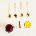 Mulled wine ingredients. Cinnamon, orange, cardamom, clove, anise and red wine on white background.