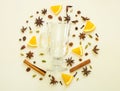 Mulled wine ingredients flat lay. Cinnamon, orange, cardamom, clove, anise and red wine on white background.