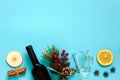 Mulled Wine Ingredients, still life on blue background. Bottle of wine, cinnamon sticks, slices of orange, apple, anise and mug. Royalty Free Stock Photo