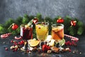 Mulled wine and mulled cider. Hot winter drinks and cocktails for christmas or new year`s eve in glass mugs with spices and citru