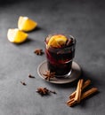 Mulled wine with orange, apple and cinnamon in glass on a dark background. The concept of a traditional winter hot drink with Royalty Free Stock Photo