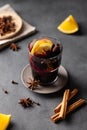 Mulled wine with orange, apple and cinnamon in glass on a dark background. The concept of a traditional winter hot drink with Royalty Free Stock Photo