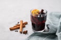 Mulled wine with orange, apple and cinnamon in glass on a light background. The concept of a traditional winter hot drink with Royalty Free Stock Photo